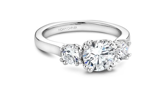 a simple three stone engagement ring by Noam Carver with a sleek band