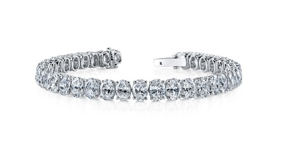 a white gold diamond tennis bracelet set with oval cut diamonds
