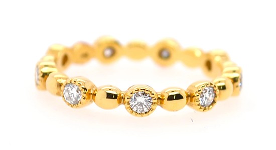 a yellow gold fashion ring featuring bezel set diamonds